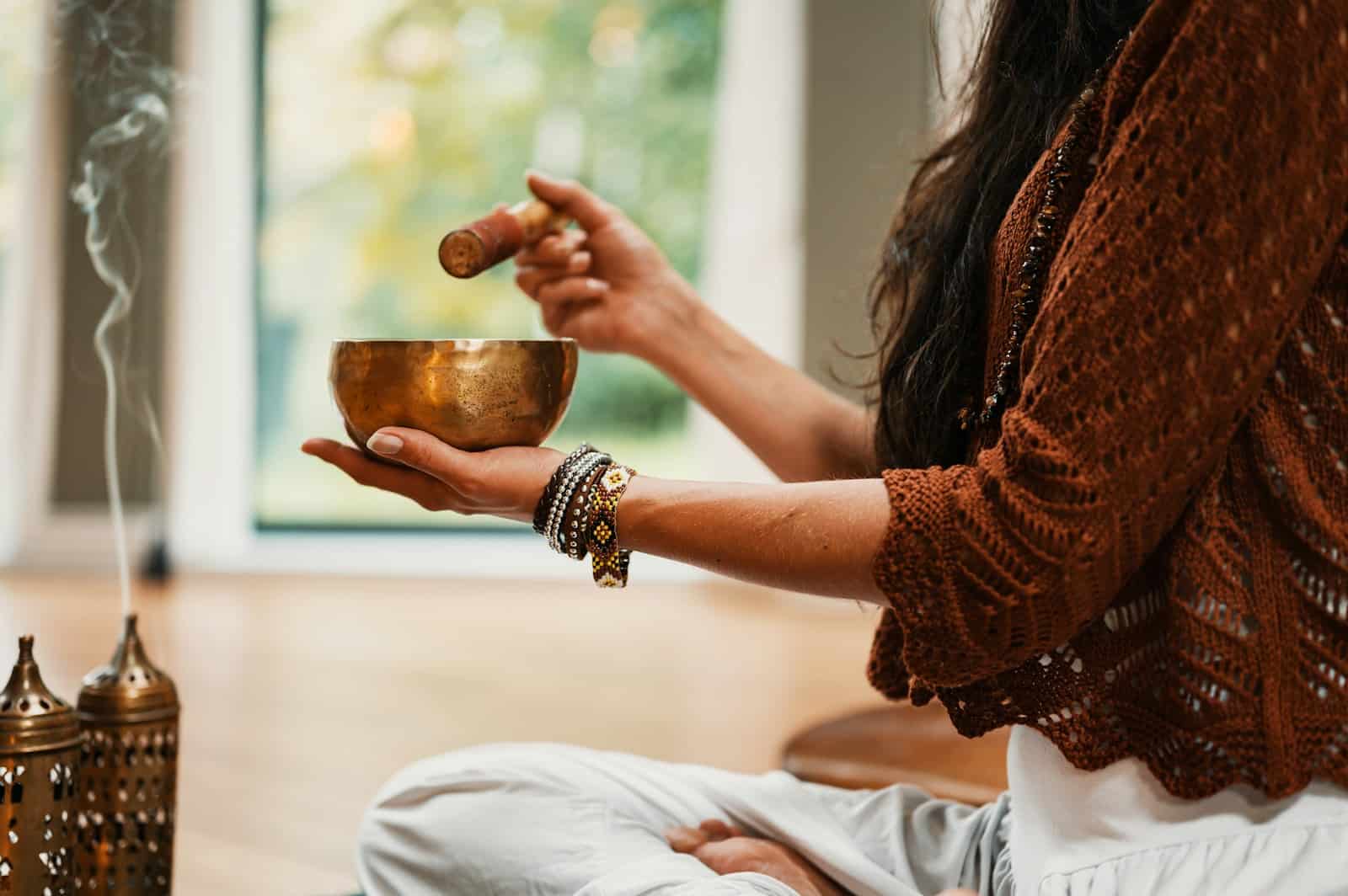 meditation, astrology, healing, woman in brown knit sweater holding brown ceramic cup